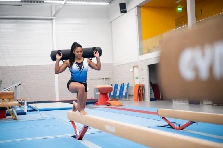Girl gymnast training on the beam with the AquaBag