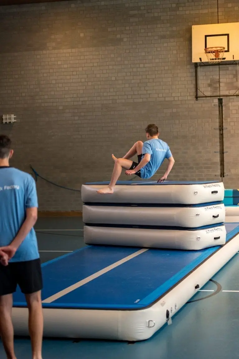 Boy freerunning over AirBox in school