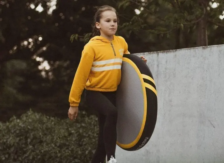 Girl carrying AirSpot S Spark up the stairs