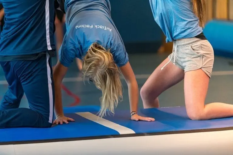 Girl doing handstand on an AirBox