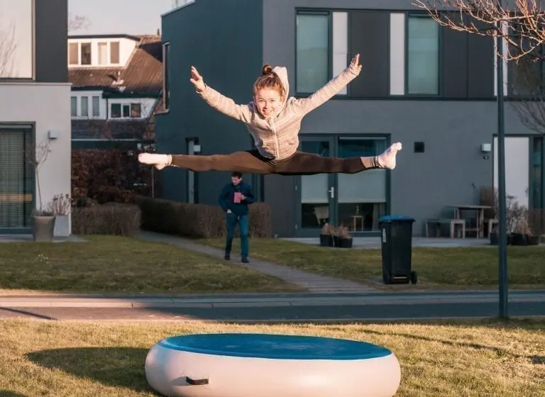 Girl jumping high on airspot outside