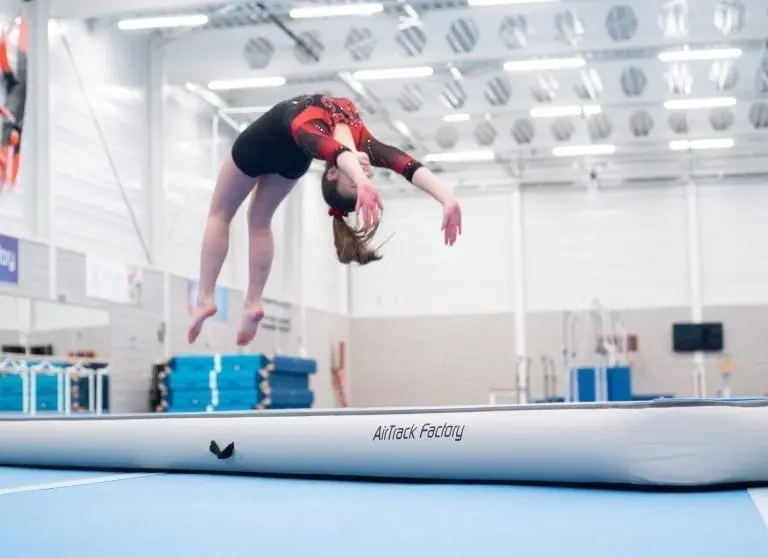 Gymnast back handspring on blue AirTrack P2