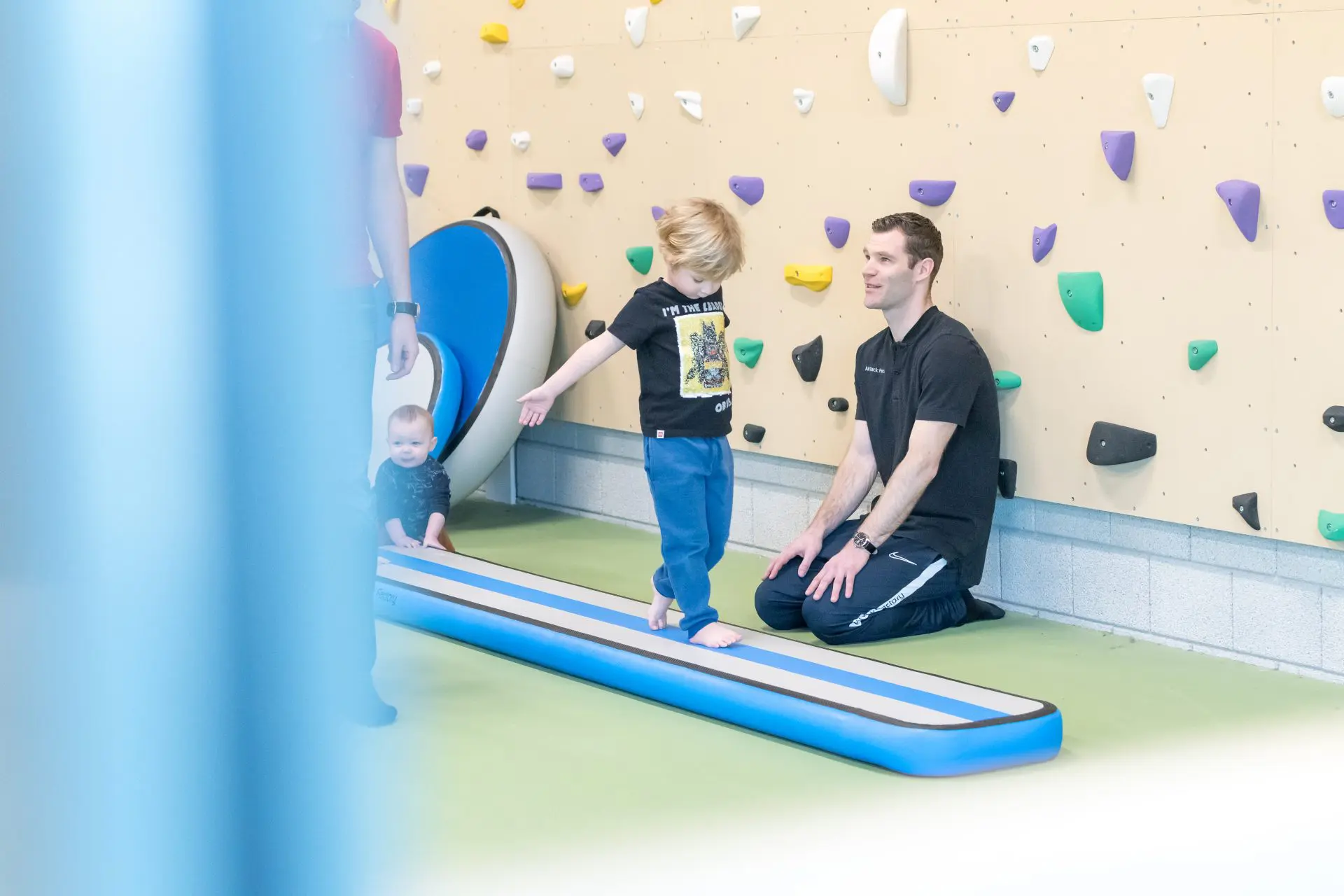 Toddler balancing on inflatable balance beam blue